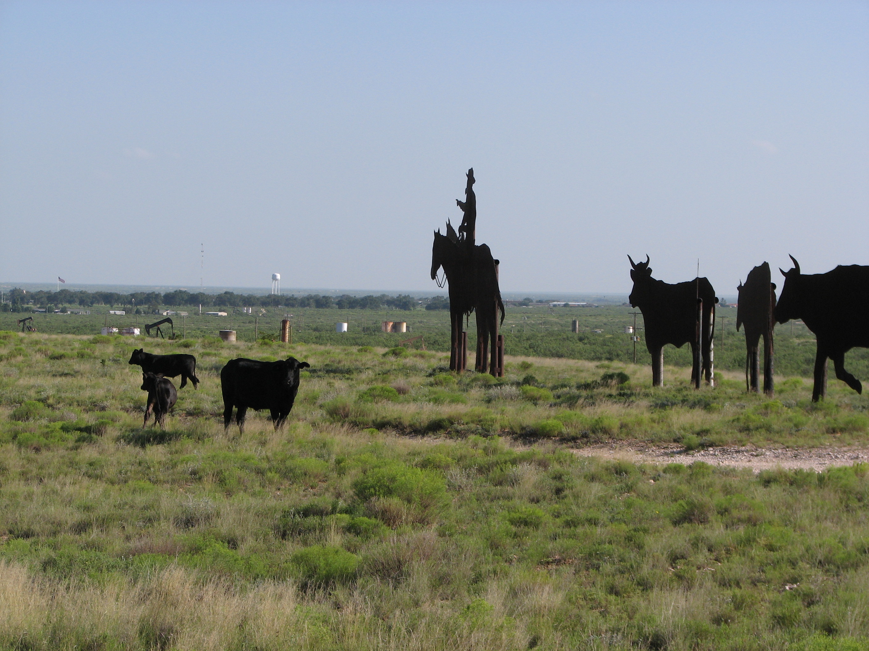 Real cows and calves pose with their much larger counterparts.